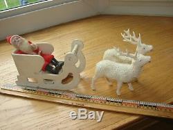 Antique Santa Claus in sleigh with two reindeer