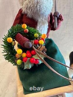 Byers Choice Santa Claus holding Wreath & Whip in Ceramic Sleigh with Reindeer