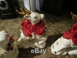 Vintage NAPCO sled and Santa Clause shaker With Reindeer Figurines Set of 4