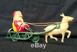 Vintage Tin Windup Celluloid Santa Claus With Sleigh Reindeer Bell Toy Christmas